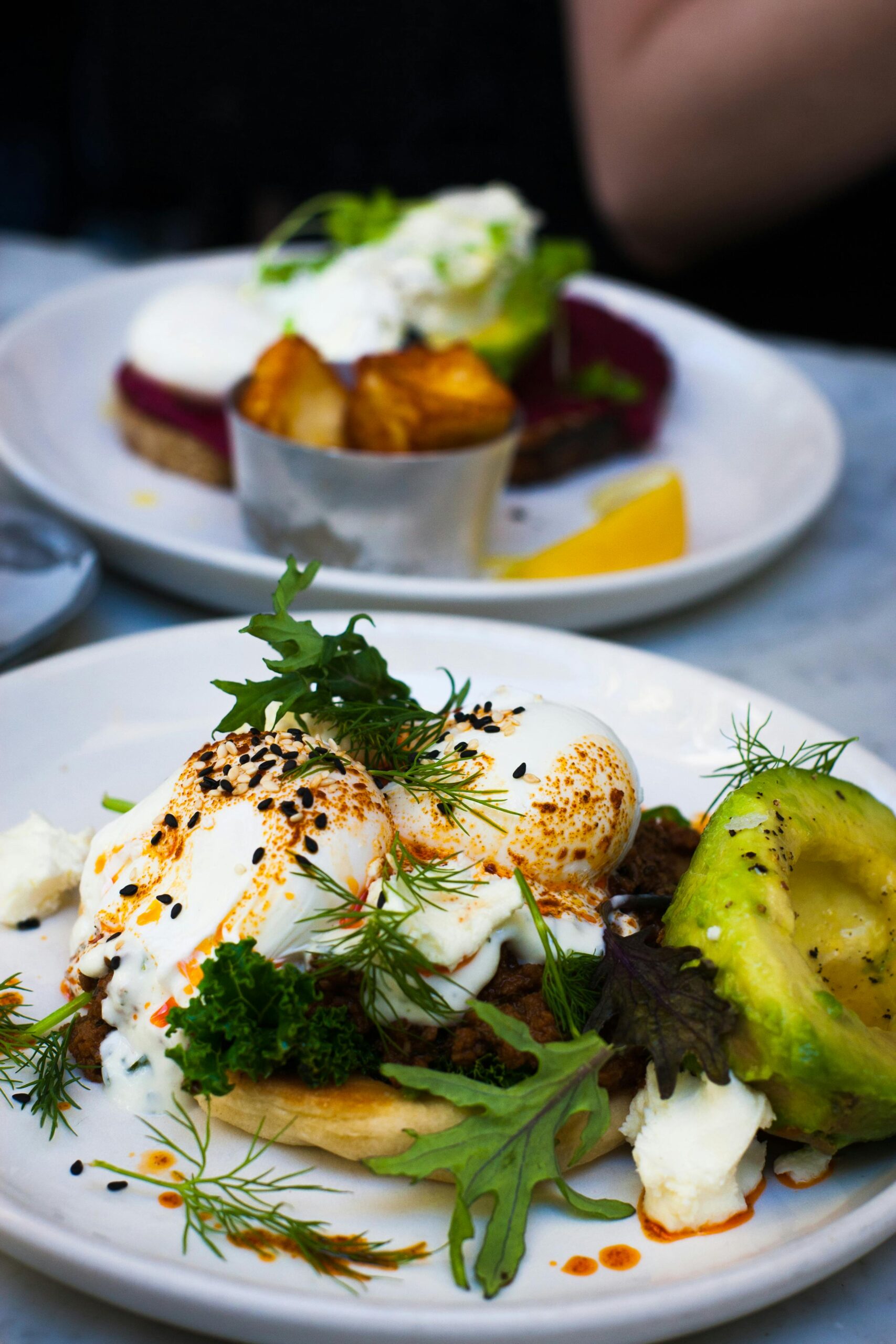 Delicious poached eggs served with avocado and fresh greens, perfect for a healthy gourmet brunch.